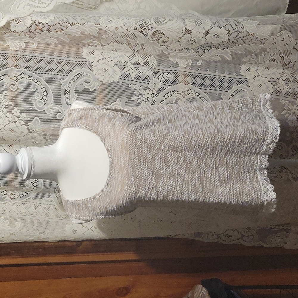 Cloth tank top with lace trim on bottom , very dressy with jeans